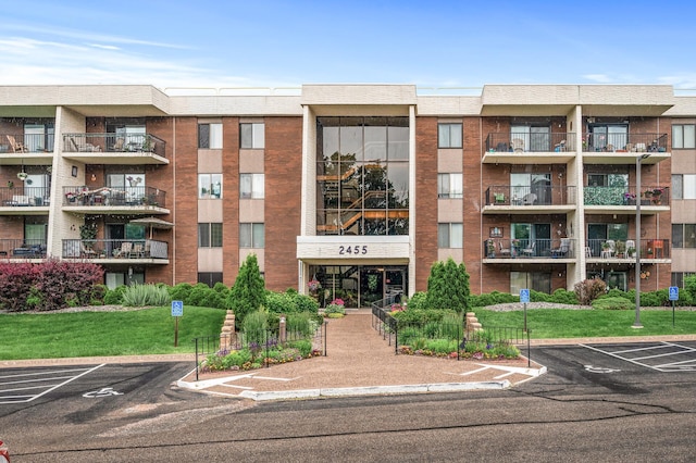 2455 Londin Ln E Unit 216, Maplewood, MN 55119 - view of apartment building / complex featuring uncovered parking