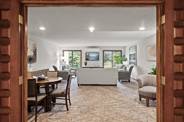 2455 Londin Ln E Unit 216, Maplewood, MN 55119 - dining room featuring carpet floors, a textured ceiling, recessed lighting, and a wall unit AC