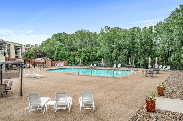 2455 Londin Ln E Unit 216, Maplewood, MN 55119 - community pool featuring a patio area and view of scattered trees