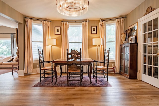 72 Mill St, Winona, MN 55987 - dining room with a chandelier, hardwood / wood-style flooring, and baseboards