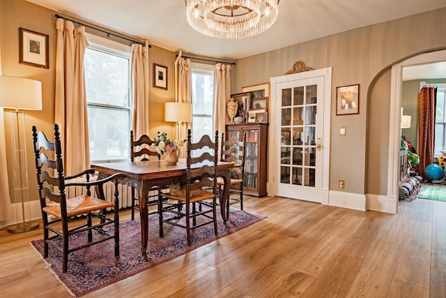 72 Mill St, Winona, MN 55987 - dining room with arched walkways, wood finished floors, baseboards, and a chandelier