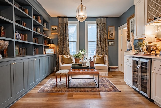 72 Mill St, Winona, MN 55987 - living area with beverage cooler, light wood-style floors, and a dry bar