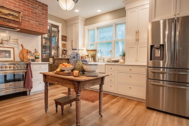 72 Mill St, Winona, MN 55987 - kitchen featuring stainless steel appliances, light wood-style floors, light countertops, white cabinetry, and recessed lighting