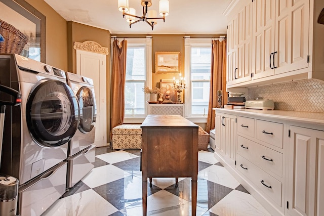 72 Mill St, Winona, MN 55987 - washroom featuring a chandelier, separate washer and dryer, and cabinet space