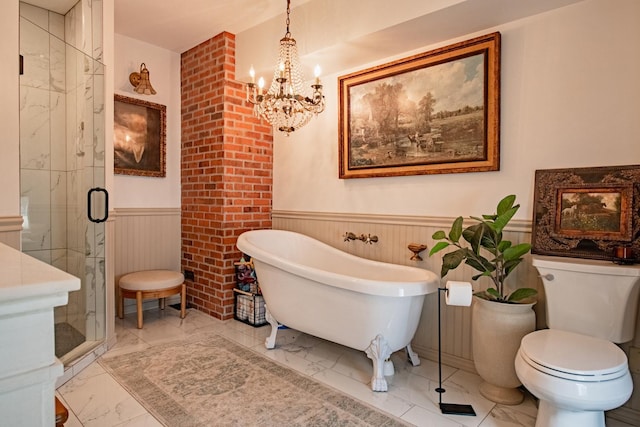 72 Mill St, Winona, MN 55987 - bathroom with a chandelier, marble finish flooring, wainscoting, a soaking tub, and a shower stall