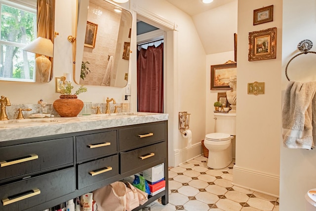 72 Mill St, Winona, MN 55987 - full bath featuring toilet, double vanity, and baseboards
