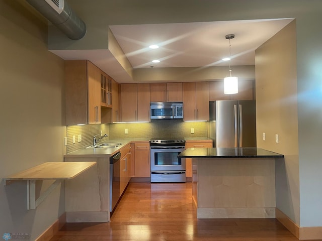 319 Broadway N Unit 207, Fargo, ND 58102 - kitchen with appliances with stainless steel finishes, a sink, light wood-style floors, baseboards, and recessed lighting