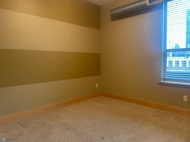 319 Broadway N Unit 207, Fargo, ND 58102 - spare room featuring carpet flooring and baseboards