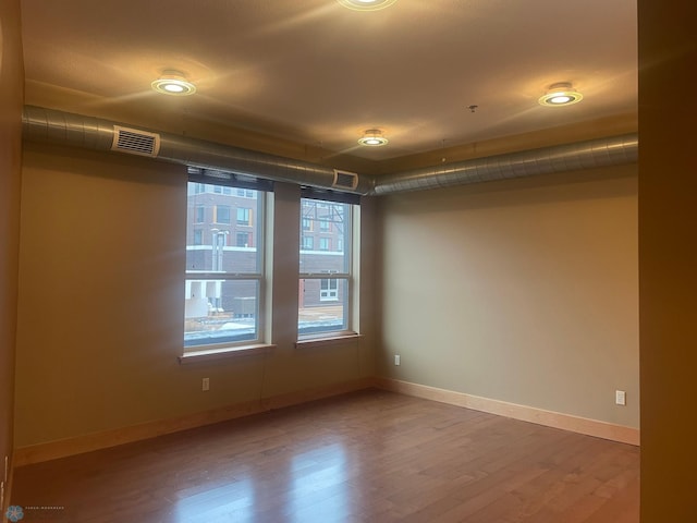 319 Broadway N Unit 207, Fargo, ND 58102 - unfurnished room with wood finished floors and baseboards