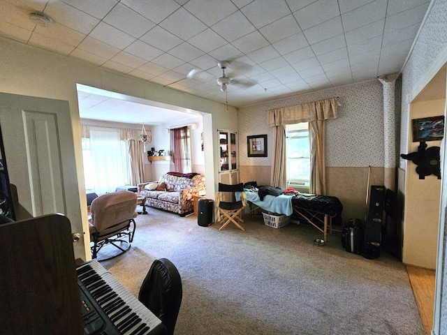 214 Vasa Ave, Fergus Falls, MN 56537 - carpeted living area featuring healthy amount of natural light, wallpapered walls, cooling unit, and ceiling fan