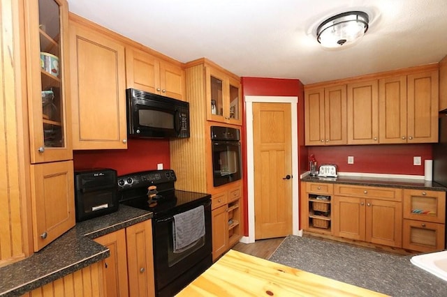 39192 460th Ave, Perham, MN 56573 - kitchen with black appliances, glass insert cabinets, and wood finished floors