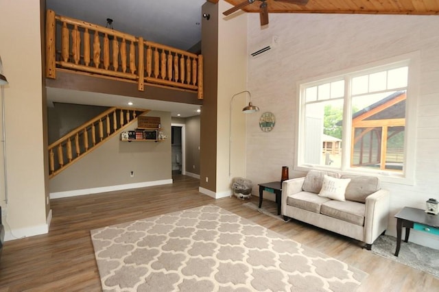 39192 460th Ave, Perham, MN 56573 - living room with ceiling fan, stairs, high vaulted ceiling, wood finished floors, and baseboards