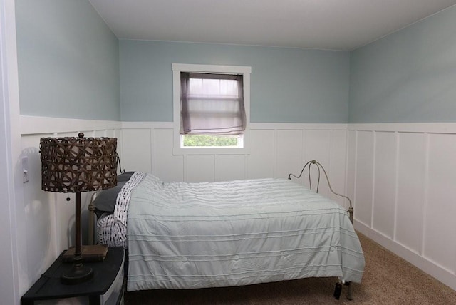 39192 460th Ave, Perham, MN 56573 - bedroom featuring wainscoting, carpet, and a decorative wall