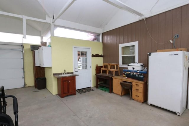 39192 460th Ave, Perham, MN 56573 - garage with freestanding refrigerator, wood walls, and a sink