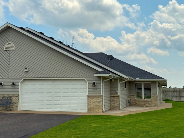 1423 Fairview Ln, Little Falls, MN 56345 - view of front of home featuring brick siding, asphalt driveway, and a shingled roof