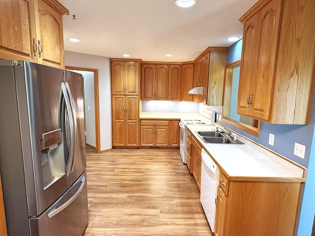 1423 Fairview Ln, Little Falls, MN 56345 - kitchen featuring white appliances, under cabinet range hood, light countertops, brown cabinets, and light wood finished floors