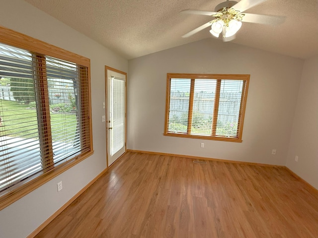 1423 Fairview Ln, Little Falls, MN 56345 - empty room with vaulted ceiling, light wood-style floors, a ceiling fan, and a textured ceiling