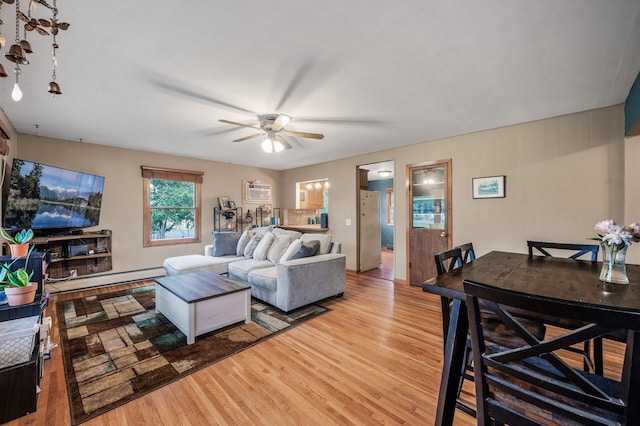 677 Quinnell Ave N, Lakeland, MN 55043 - living room with light wood finished floors, ceiling fan, a baseboard heating unit, and an AC wall unit