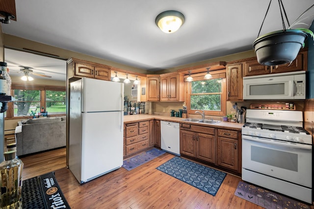 677 Quinnell Ave N, Lakeland, MN 55043 - kitchen with white appliances, a sink, light countertops, and light wood-style flooring