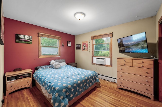 677 Quinnell Ave N, Lakeland, MN 55043 - bedroom featuring baseboard heating, light wood finished floors, and cooling unit