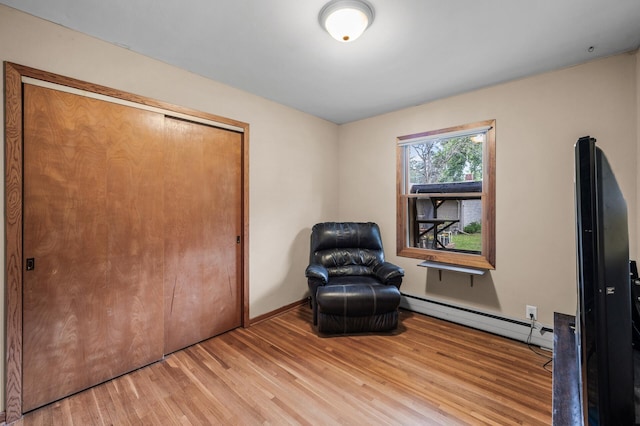 677 Quinnell Ave N, Lakeland, MN 55043 - sitting room with a baseboard heating unit, light wood finished floors, and baseboards