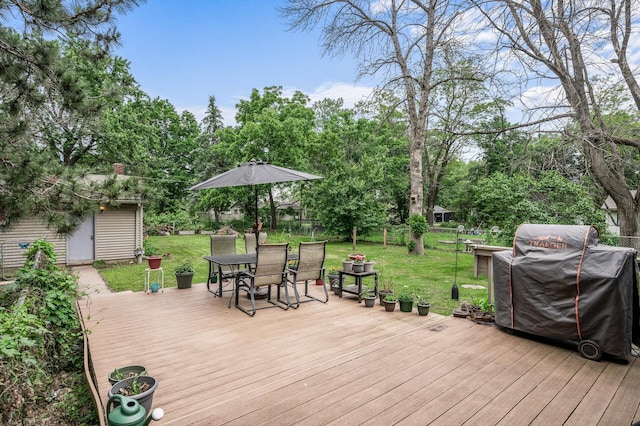 677 Quinnell Ave N, Lakeland, MN 55043 - deck with outdoor dining space, a grill, an outbuilding, and view of scattered trees