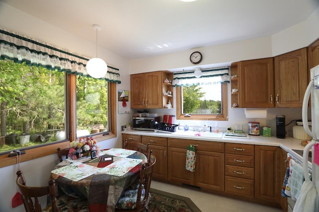 3883 Pleasant Ln, Fayal Twp, MN 55734 - kitchen featuring open shelves, light countertops, and brown cabinetry