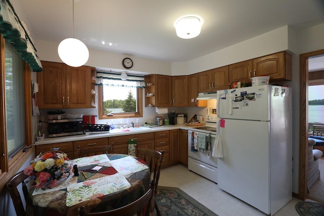 3883 Pleasant Ln, Fayal Twp, MN 55734 - kitchen featuring white appliances, under cabinet range hood, light countertops, brown cabinetry, and open shelves