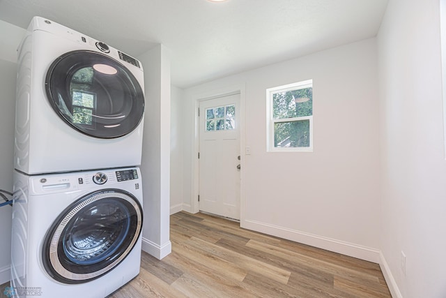 1814 5th St N, Fargo, ND 58102 - laundry area with stacked washer / dryer, light wood-style floors, and baseboards