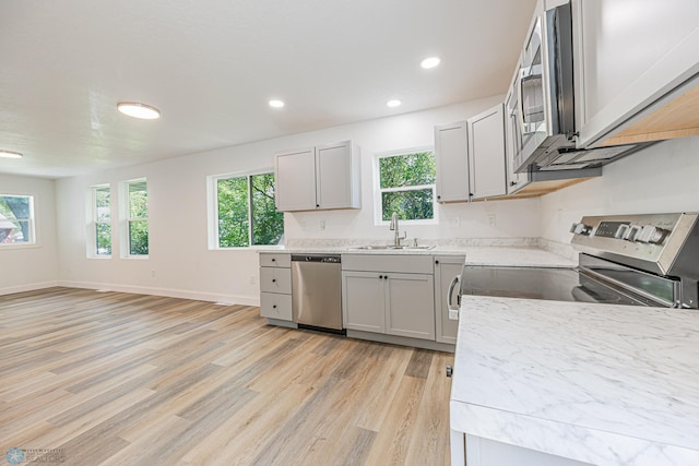 1814 5th St N, Fargo, ND 58102 - kitchen featuring appliances with stainless steel finishes, a sink, light wood-style flooring, plenty of natural light, and recessed lighting