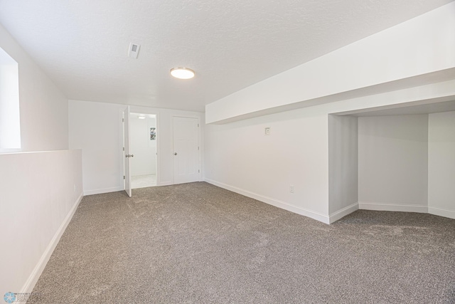 1814 5th St N, Fargo, ND 58102 - finished basement with carpet, baseboards, and a textured ceiling