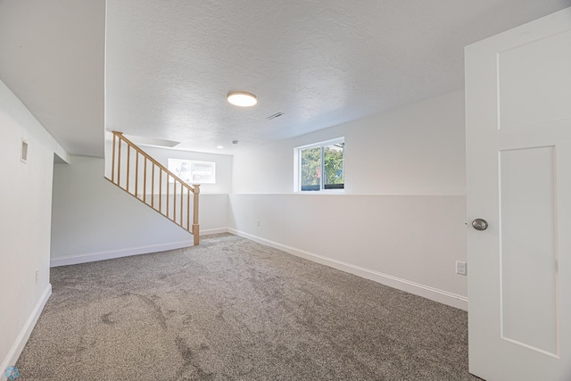 1814 5th St N, Fargo, ND 58102 - carpeted spare room with stairs, baseboards, and a textured ceiling