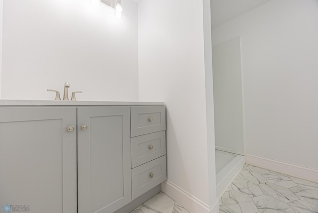 1814 5th St N, Fargo, ND 58102 - bathroom with marble finish floors, baseboards, a shower, and a sink