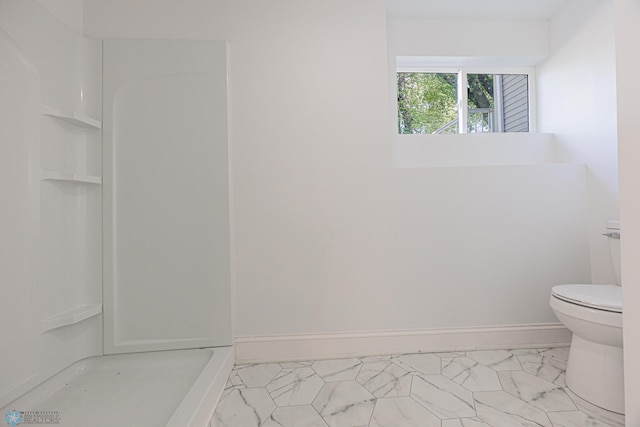 1814 5th St N, Fargo, ND 58102 - full bathroom featuring toilet, a shower, marble finish flooring, and baseboards