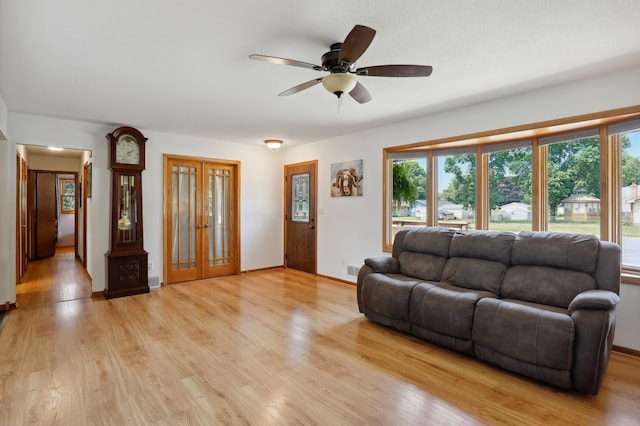 1412 10th Ave W, Shakopee, MN 55379 - living room featuring a ceiling fan, light wood-style flooring, french doors, and baseboards