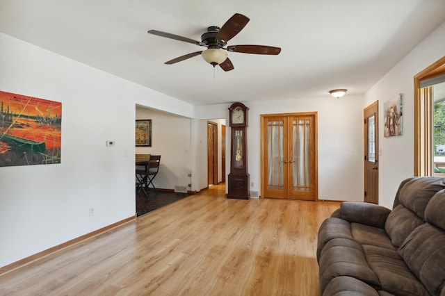 1412 10th Ave W, Shakopee, MN 55379 - living area with light wood-style flooring, ceiling fan, french doors, and baseboards