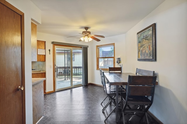 1412 10th Ave W, Shakopee, MN 55379 - dining area featuring baseboards, a ceiling fan, and dark flooring