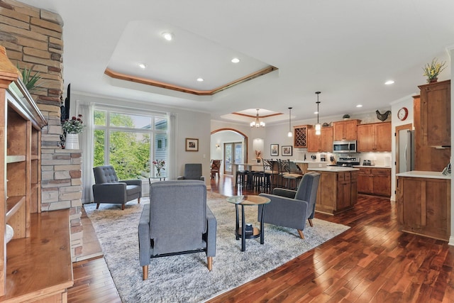 13478 Clearwater Cir, Rogers, MN 55374 - living area featuring arched walkways, plenty of natural light, crown molding, dark wood-style floors, and a tray ceiling