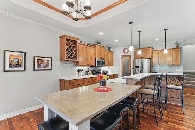 13478 Clearwater Cir, Rogers, MN 55374 - kitchen featuring stainless steel appliances, brown cabinets, light countertops, a chandelier, and ornamental molding