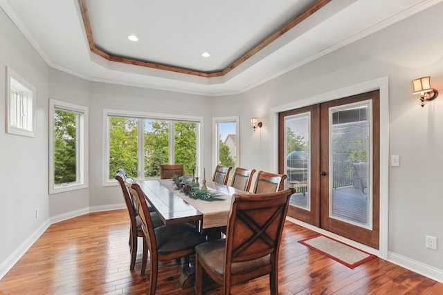 13478 Clearwater Cir, Rogers, MN 55374 - dining space featuring french doors, hardwood / wood-style flooring, a tray ceiling, crown molding, and recessed lighting