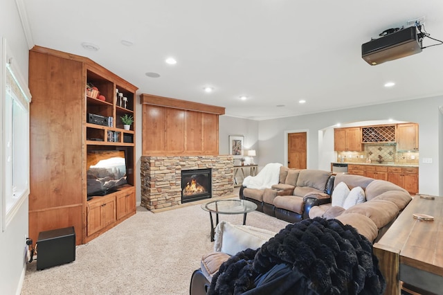 13478 Clearwater Cir, Rogers, MN 55374 - carpeted living room featuring ornamental molding, a stone fireplace, recessed lighting, and bar