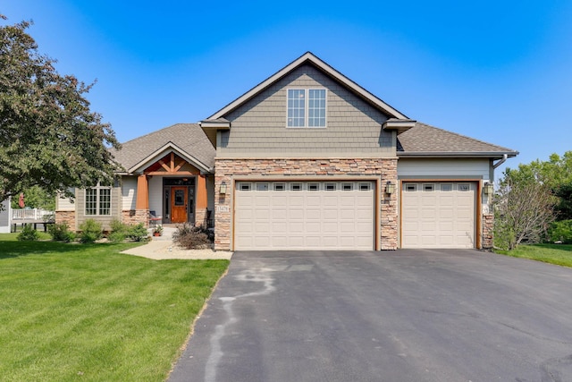 13478 Clearwater Cir, Rogers, MN 55374 - craftsman-style home with stone siding, asphalt driveway, a front yard, a garage, and roof with shingles