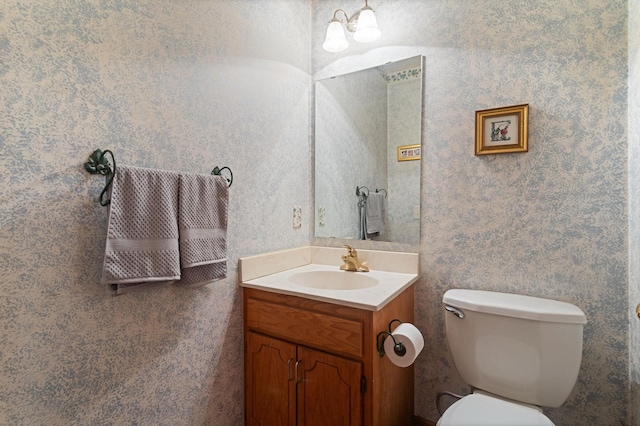 1580 9th Street Cir SE, Forest Lake, MN 55025 - bathroom with vanity, toilet, and wallpapered walls