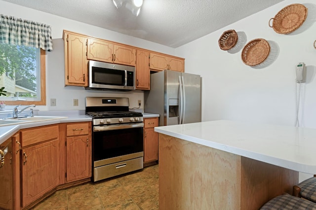 1580 9th Street Cir SE, Forest Lake, MN 55025 - kitchen with stainless steel appliances, light countertops, a sink, and a textured ceiling