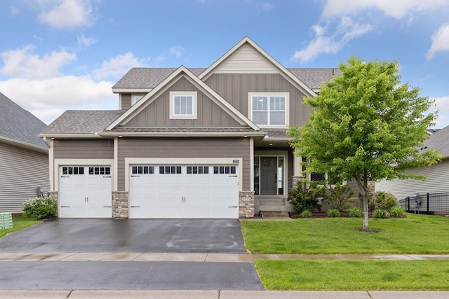 5175 White Star Ln, Woodbury, MN 55129 - craftsman house with board and batten siding, driveway, a shingled roof, and a garage
