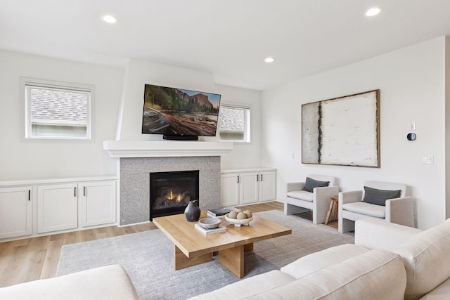 5175 White Star Ln, Woodbury, MN 55129 - living room featuring light wood-style floors, a glass covered fireplace, and recessed lighting