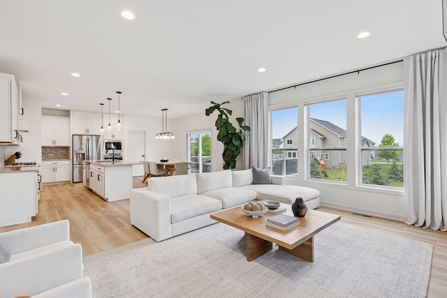 5175 White Star Ln, Woodbury, MN 55129 - living area with recessed lighting, light wood-style floors, and a chandelier