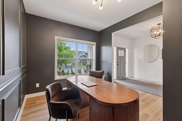5175 White Star Ln, Woodbury, MN 55129 - home office with light wood-type flooring, baseboards, and a chandelier