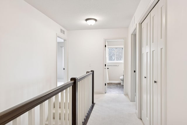5175 White Star Ln, Woodbury, MN 55129 - hall featuring an upstairs landing, light carpet, a textured ceiling, and baseboards