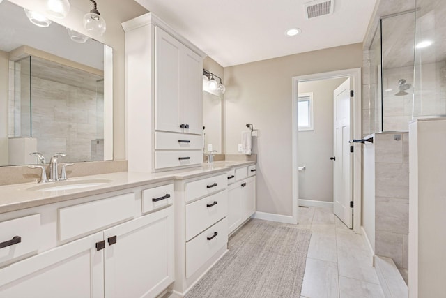 5175 White Star Ln, Woodbury, MN 55129 - bathroom featuring double vanity, a tile shower, baseboards, marble look tile flooring, and recessed lighting